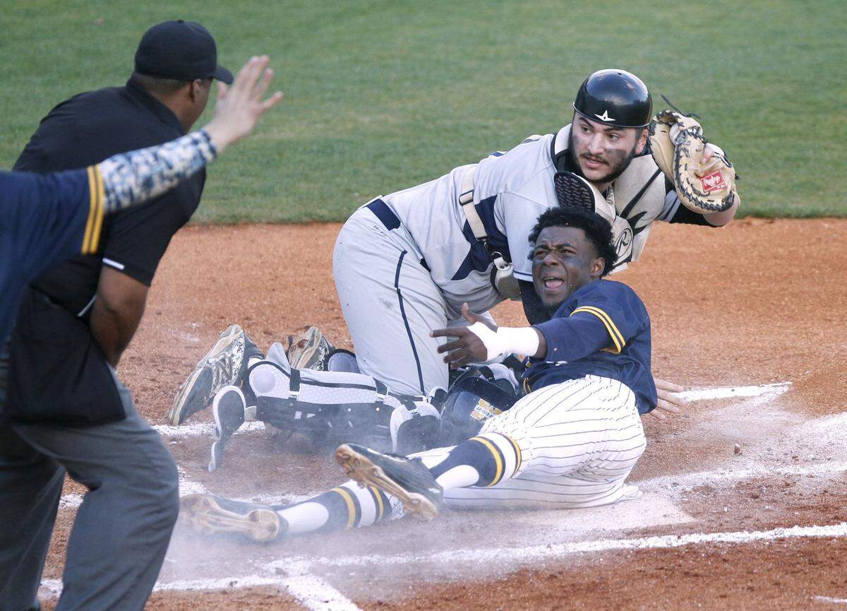 TIM ISBELL/SUN HERALD  MGCCC second baseman Marcus Buckley and St. Louis catcher David Prost plead their case as the umpire signals Buckley safe during first game of double header, Friday, Feb. 12, 2016.