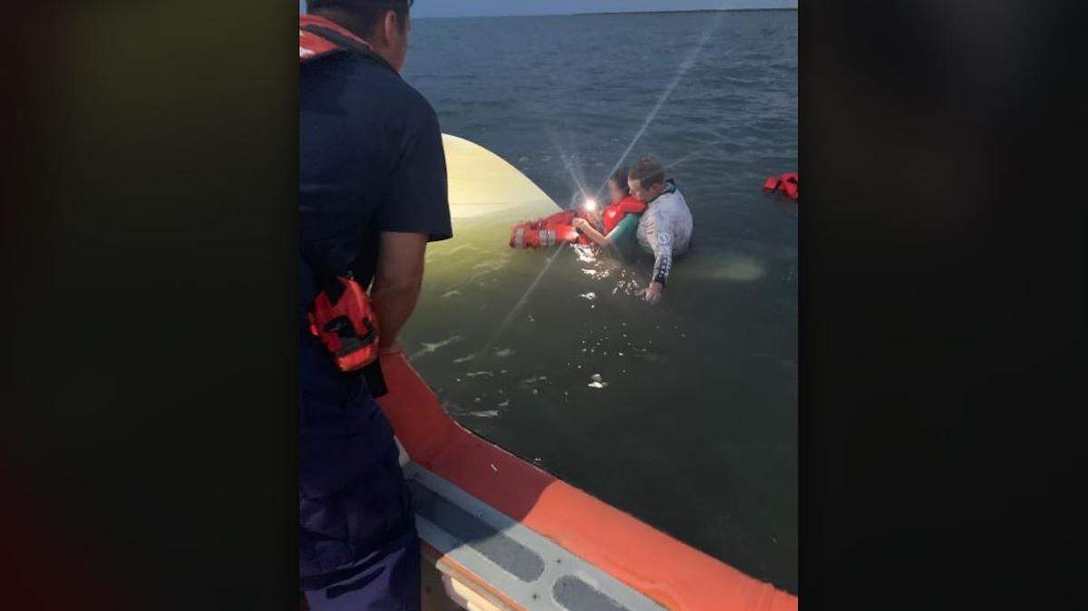 The Coast Guard rescue a man and child from a capsized boat Sunday evening. No injuries were reported.