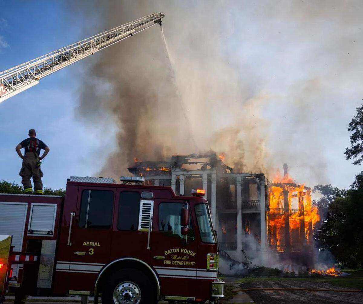 Firefighters from Baton Rouge operate Aerial 3 as flames engulf the Nottoway Plantation on Thursday, May 15, 2025, in White Castle, Louisiana.
