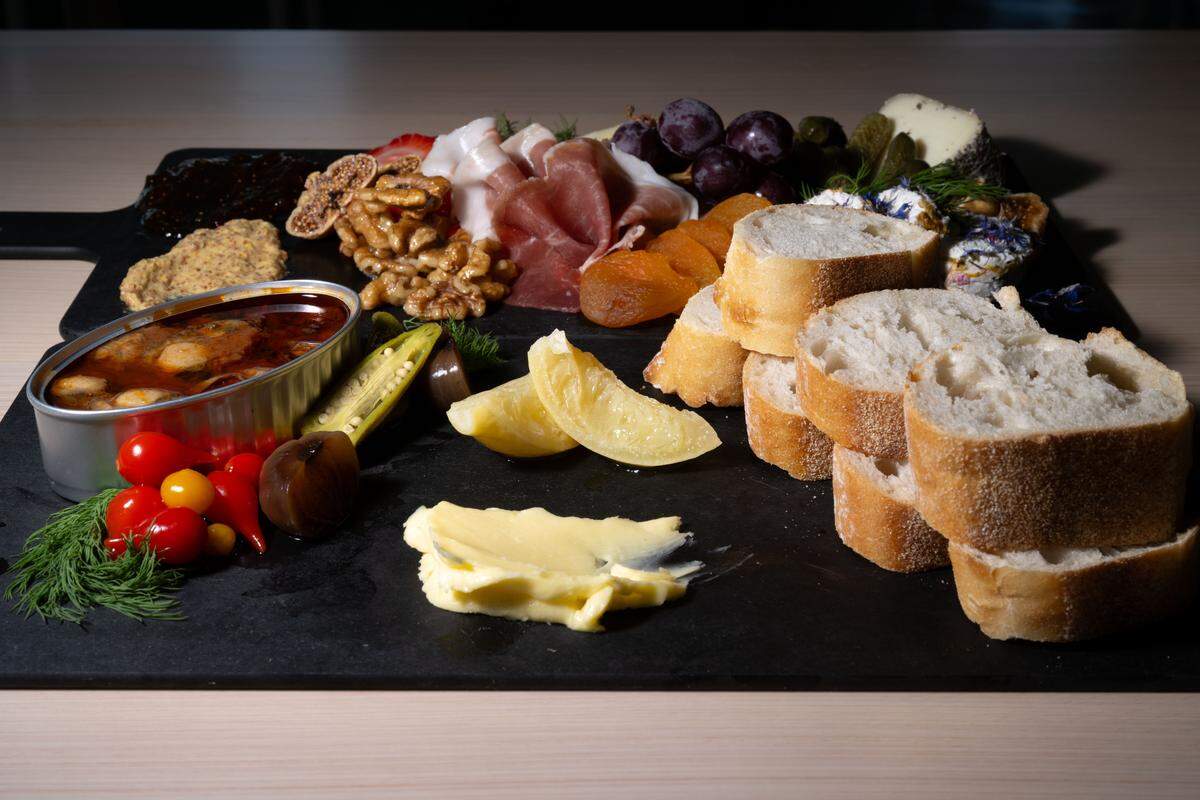 The charcuterie board, back, and the Tin of the Week, front, at St. James Cheese Company in Pass Christian.