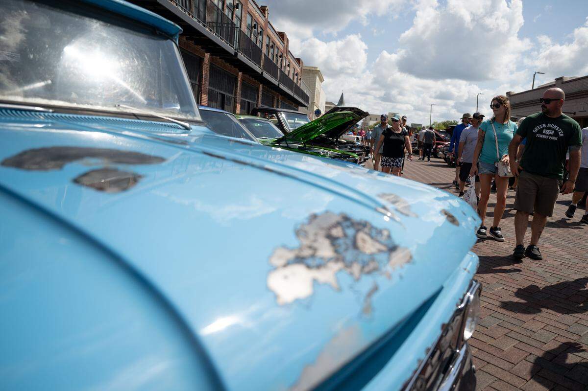 Event attendees check out cars Wednesday at the Biloxi Block Party.