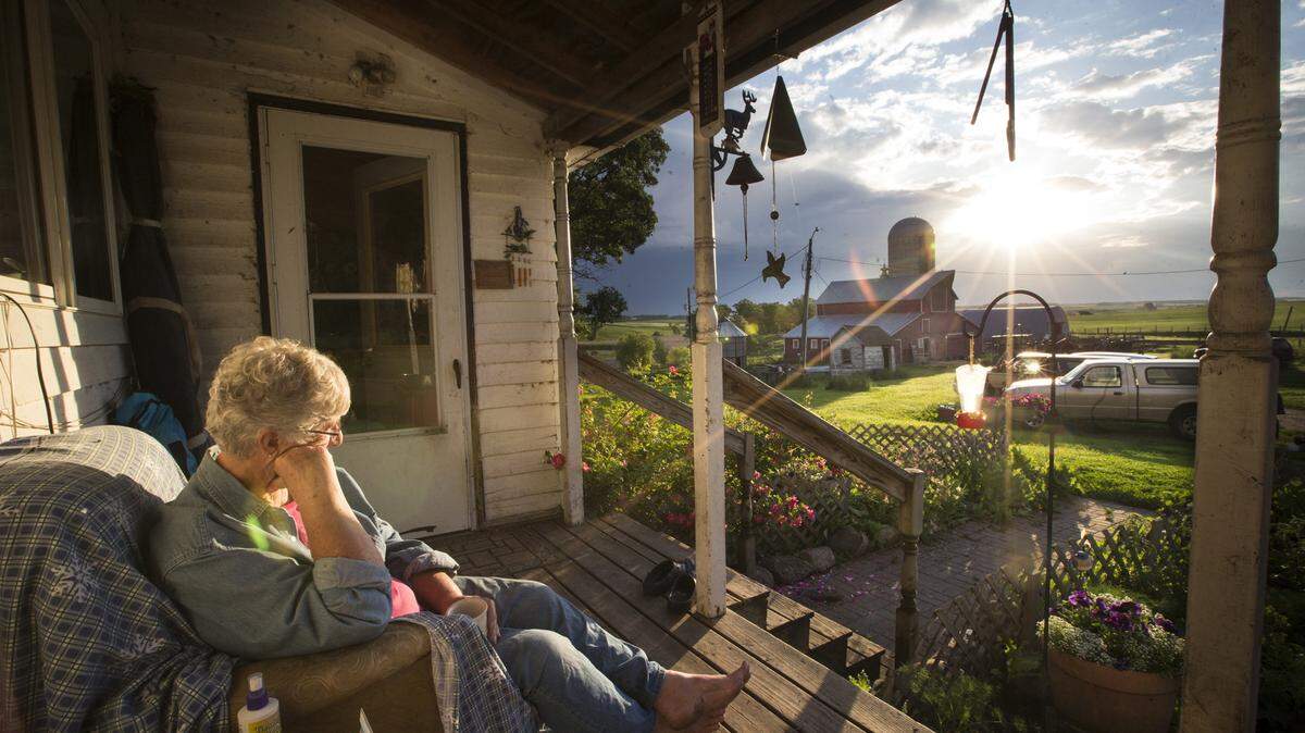 Ann Guenther sits on her front porch on her farm on June 22, 2015 in Waubun, Minn. She used to sit on the porch with her husband Ray before he died in a farm accident in 2011. (Renee Jones Schneider/Minneapolis Star Tribune/TNS)