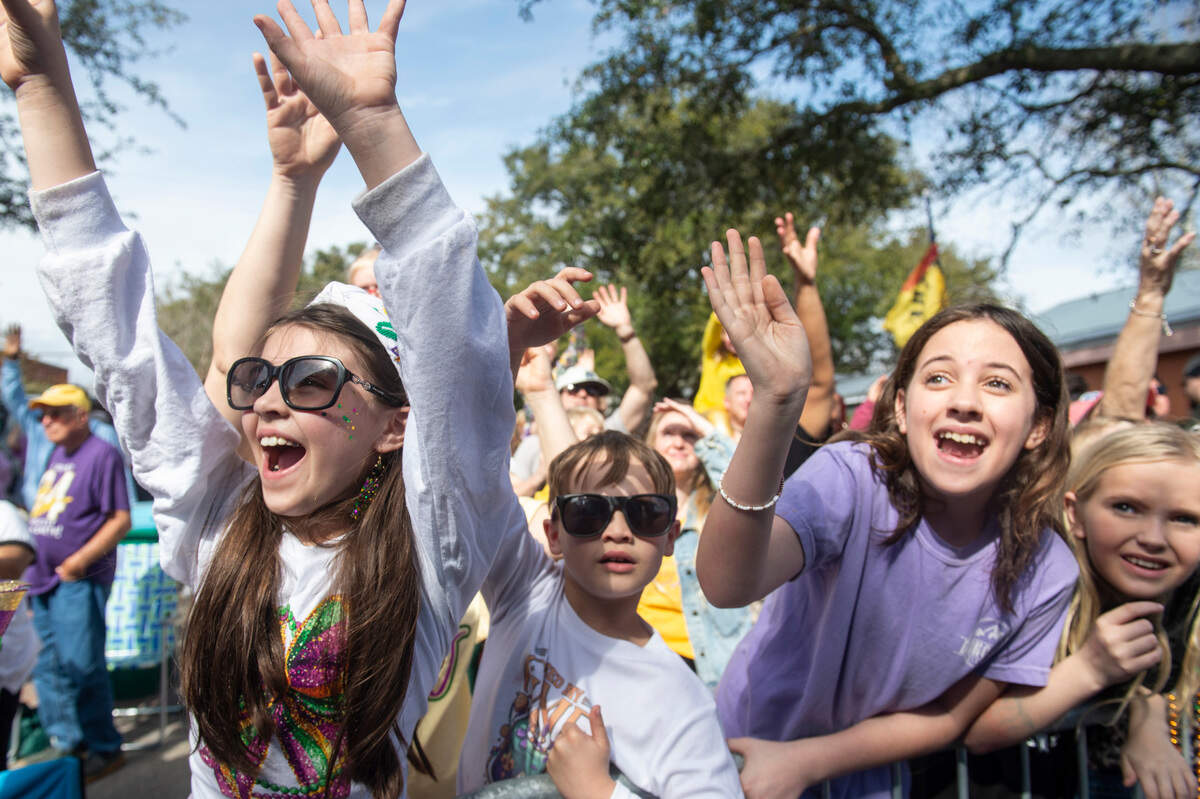 Children cheer for throws during the Ocean Springs Elks Club Mardi Gras Parade in Ocean Springs on Saturday, Feb. 15, 2025.