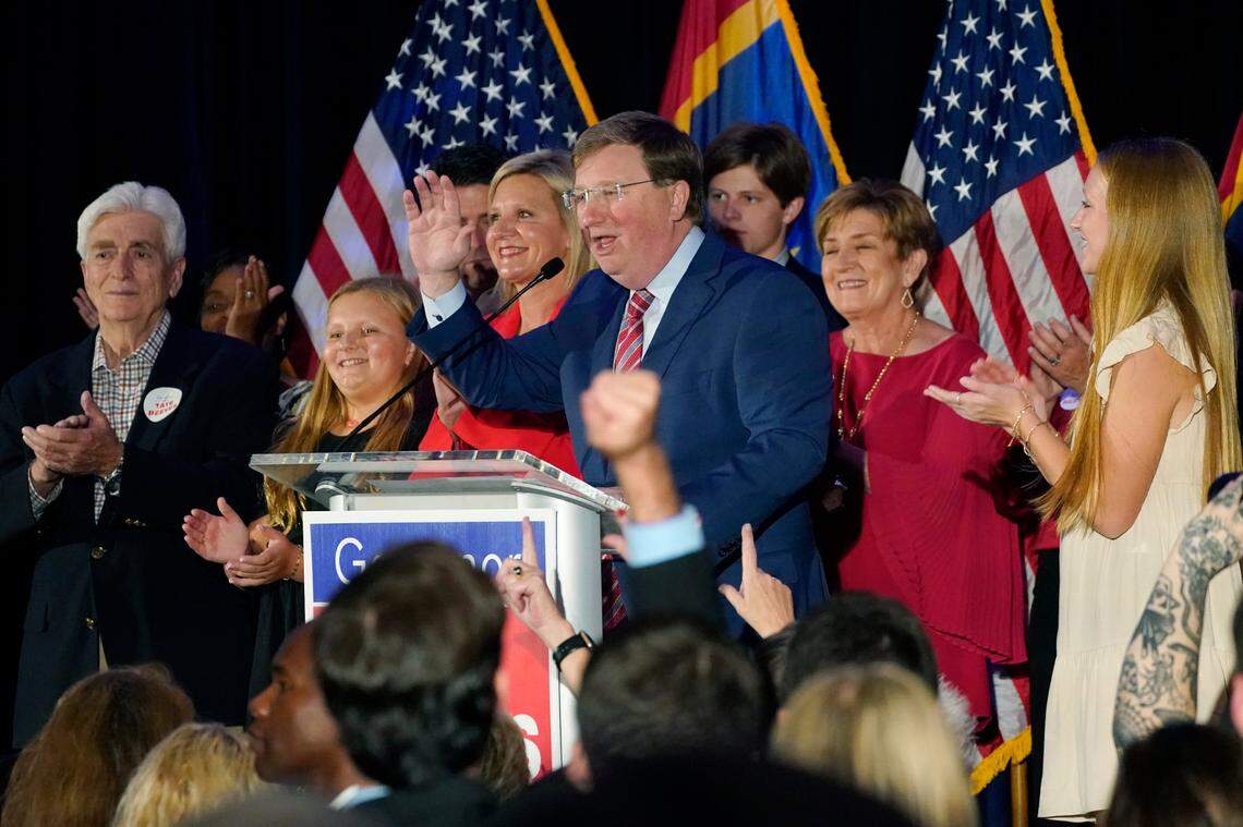 Surrounded by family, Mississippi Republican Gov. Tate Reeves speaks at a election night party in Flowood. Reeves won a second term, defeating Democrat Brandon Presley.