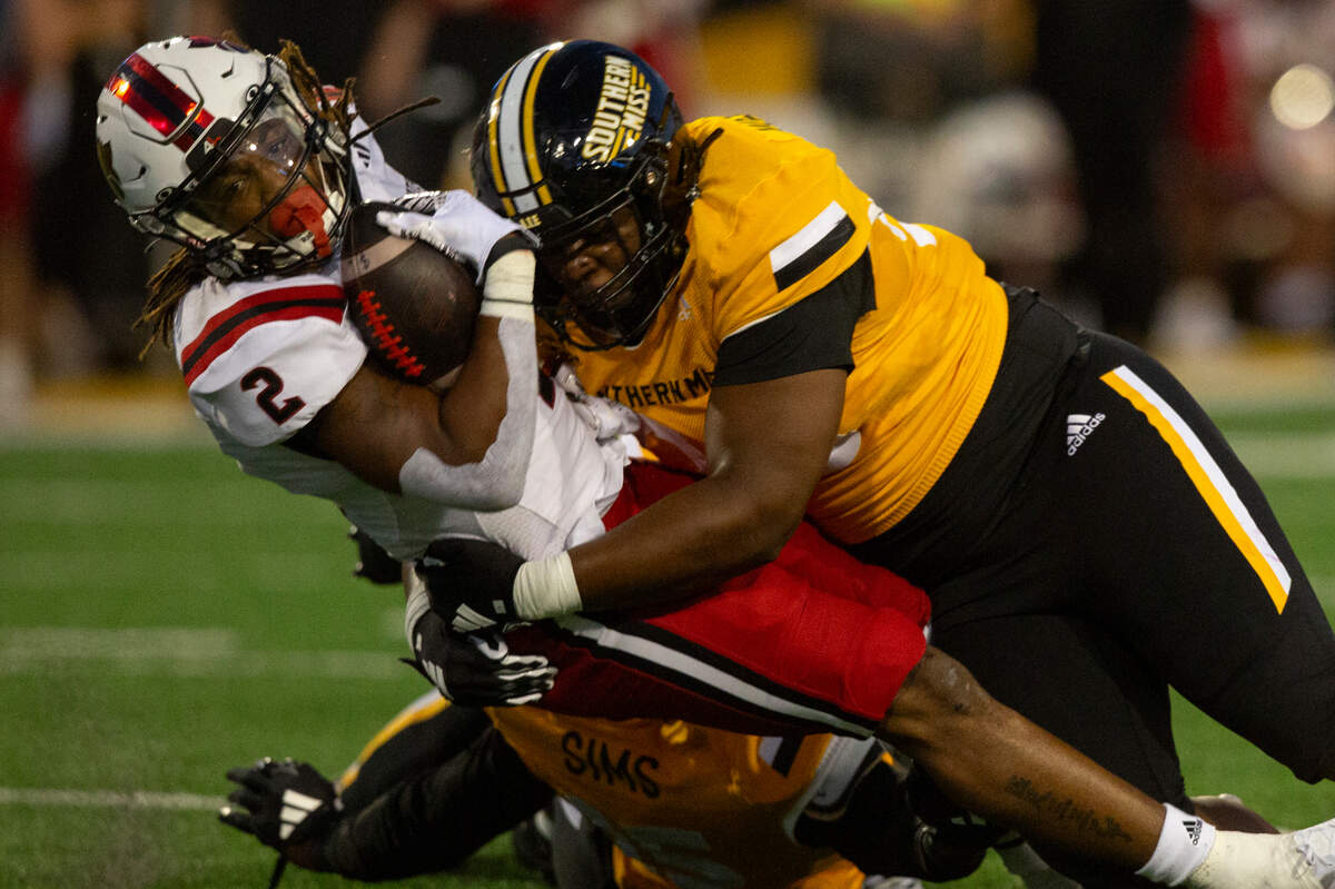 Southern Miss Golden Eagles defense tackles Arkansas State Red Wolves running back Ja’Quez Cross (2) during a game between Southern Miss and Arkansas State at M.M. Roberts Stadium in Hattiesburg on Saturday, Oct. 19, 2024.