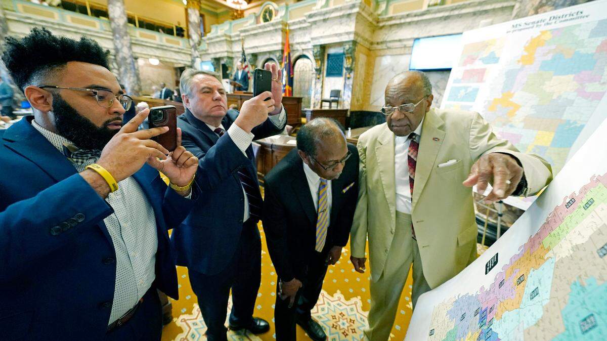 Mississippi state Sens. Rod Hickman, D-Macon, left; Michael McLendon, R-Hernando, second from left; Albert Butler, D-Port Gibson; and David Jordan, D-Greenwood, review an alternate Senate redistricting map during debate on the floor of the Senate at the state Capitol in Jackson in 2022. Three federal judges started hearing arguments on Monday in a lawsuit that challenges the racial composition of some Mississippi House and Senate districts.