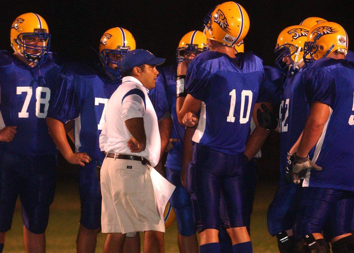 Bay High coach Brenan Compretta talks to his players during a time out of their game against Long Beach, Monday, Sept. 26, 2005 in Bay St. Louis.