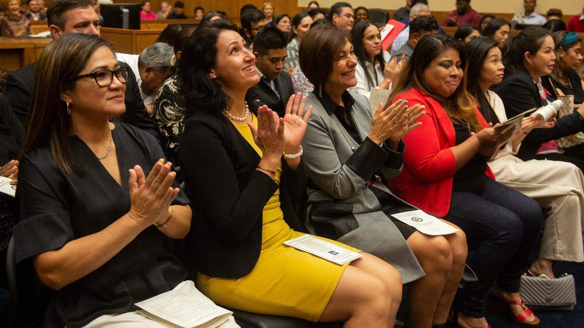 Newly naturalized citizens celebrate after being confirmed as new American citizens during a naturalization ceremony at Dan M. Russell Jr. Federal Courthouse in Gulfport on Friday, Oct. 7, 2022.