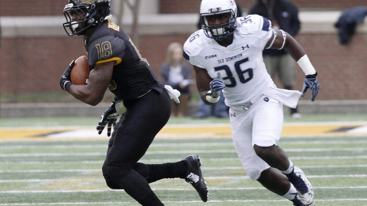 TIM ISBELL/SUN HERALDSouthern Miss receiver Korey Robertson runs for extra yards after making a catch, Saturday, Nov. 21, 2015. Old Dominion's Martez Simpson moves in for the tackle. 