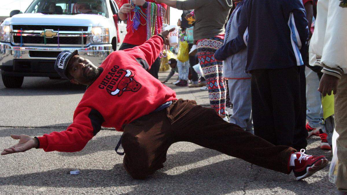 SHANNON DAVIDSON/SPECIAL TO THE SUN HERALD 
 Pascagoula native John Davis dances on Market Street in downtown Pascagoula during the Jackson County Carnival Association parade Saturday, Feb. 6, 2016.