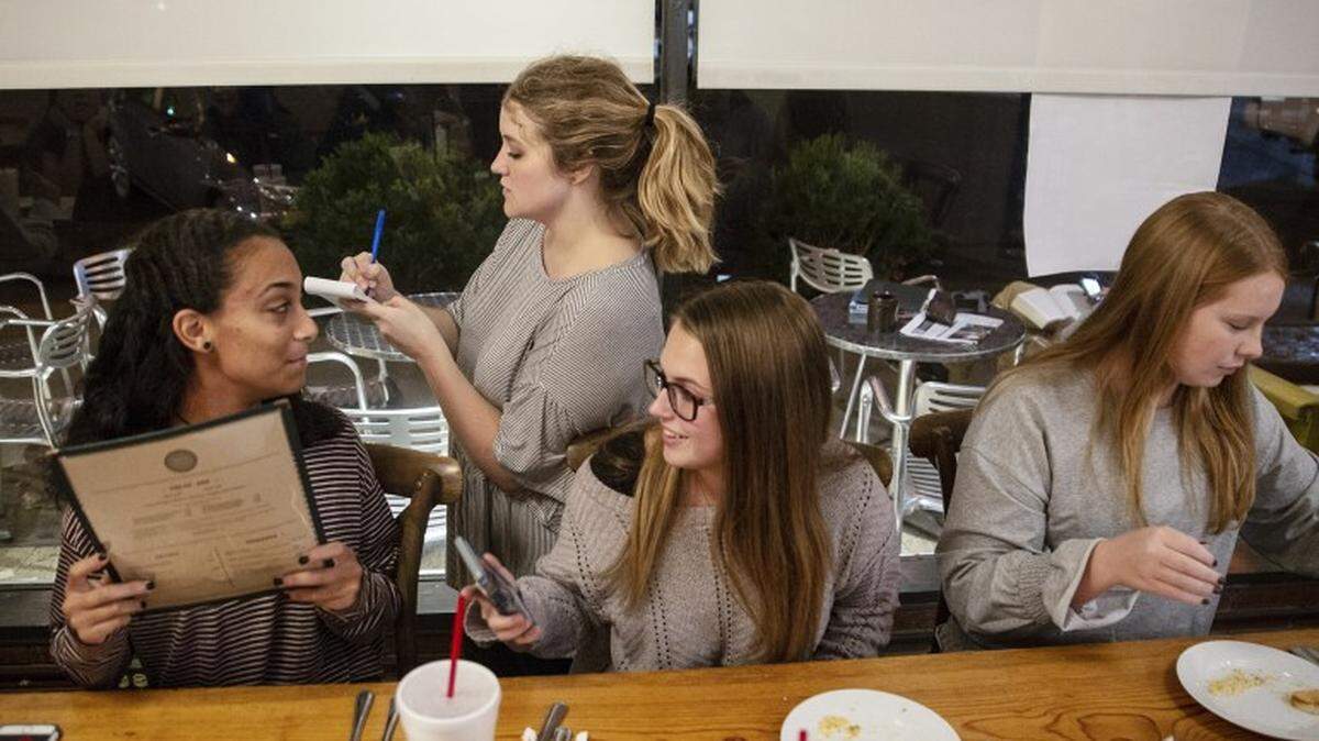 Kaitlyn Barton writes down orders while waiting a table of young students at her second job at Yazoo Pass in Clarksdale Wednesday, October 31, 2018. At that point, she worked both a waitress job and her full-time teaching job to make ends meet.
