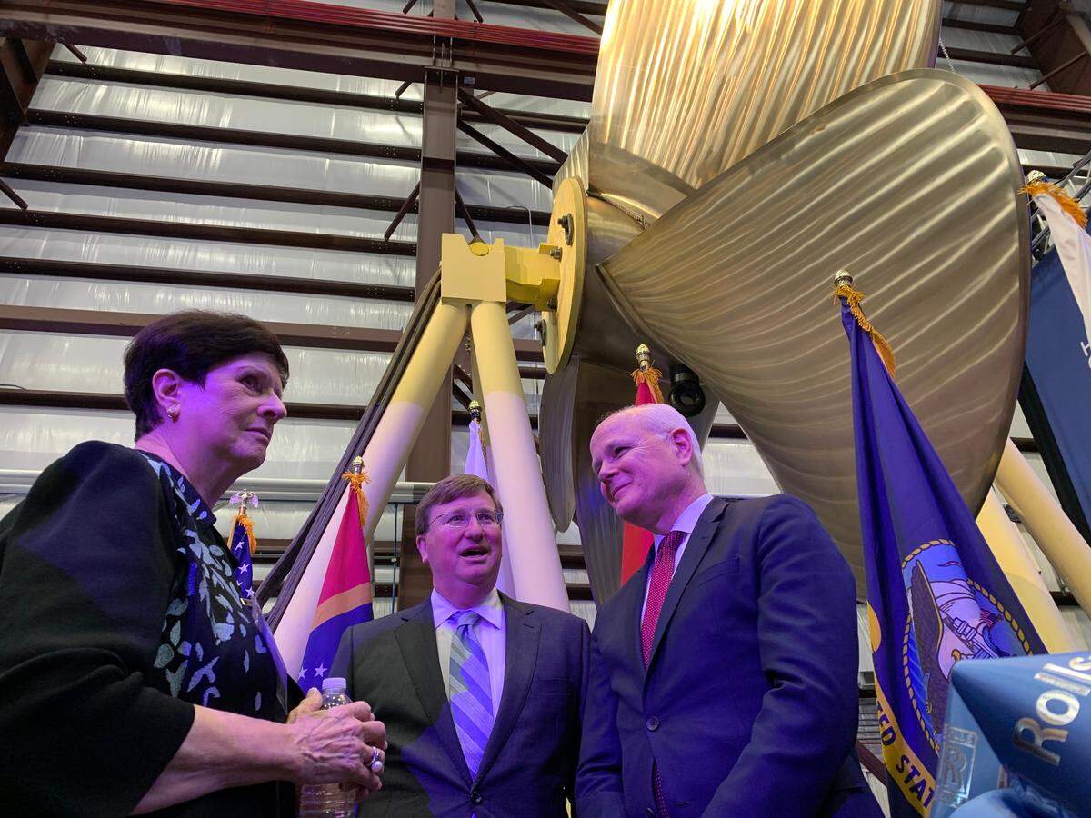 Gov. Tate Reeves, center, stands beneath a propeller manufactured at the new Rolls-Royce center in Pascagoula. At left is Myrtis Franke, representative for U.S. Sen. Cindy Hyde-Smith, and at right is Tom Bell, chairman of Rolls-Royce North America. The Pascagoula division is being sold by Rolls Royce.