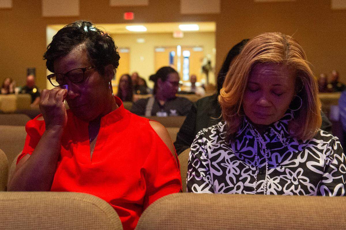 Lisa Godine and Paula Gray listen during a coast-wide candlelight ceremony as a part of National Crime Victims’ Rights Week at First Baptist Church of Gulfport on Tuesday, April 29, 2025. Gray’s sister Shantel Dedeaux was killed in a murder suicide in 2003.