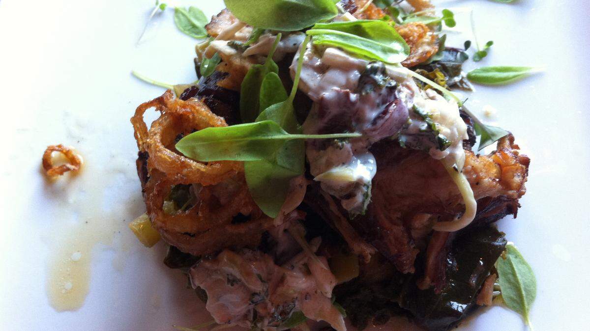 TAMMY SMITH/SUN HERALDBraised Berkshire Pork Belly at Corks & Cleaver Wine Bistro in Gulfport includes creamy potato cake, slow cooked greens, Southern style slaw and beer battered shallot rings.
