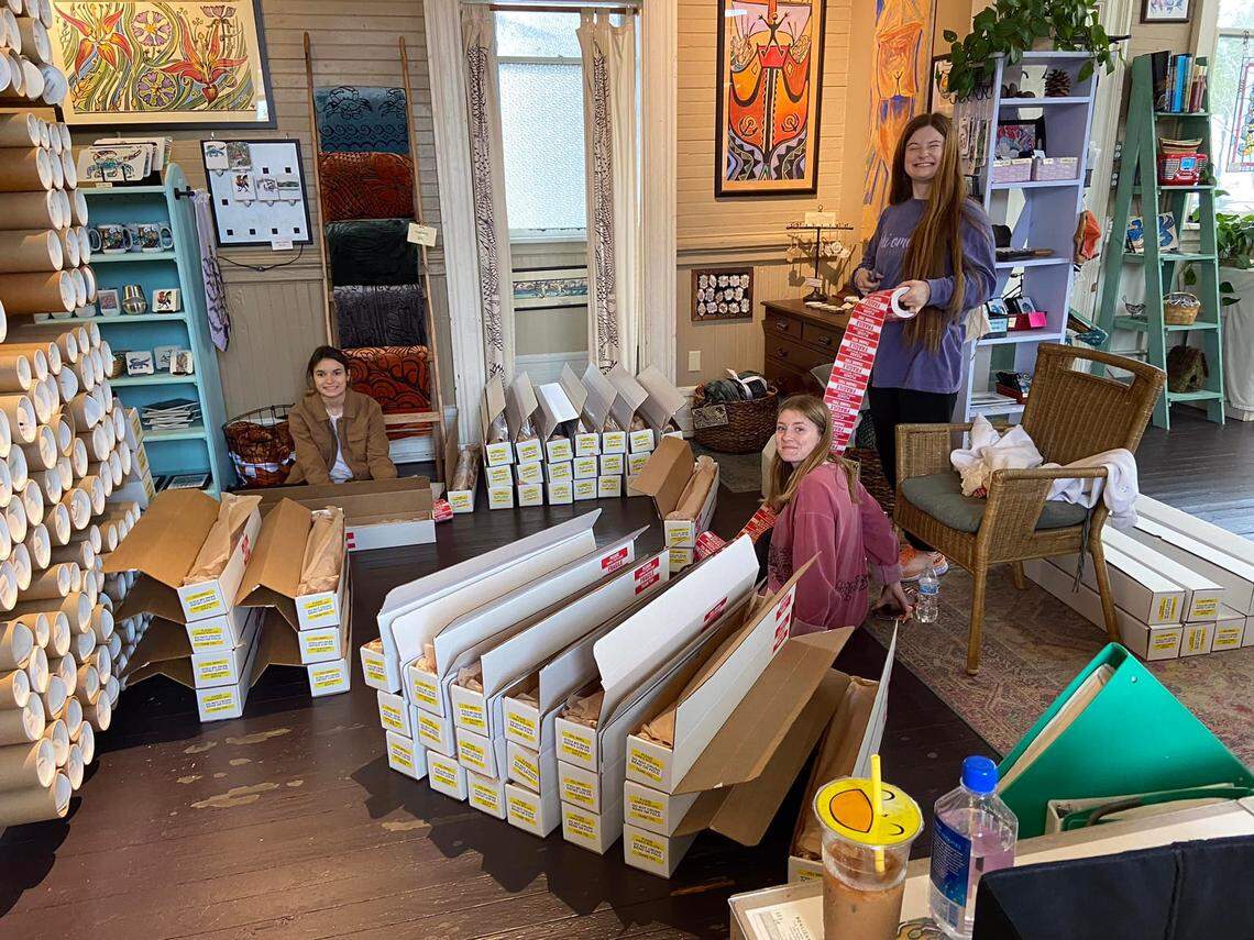 The staff at Realizations Ltd. packs Walter Anderson prints made by Patricia Anderson after the artist was featured on the HGTV show “Hometown” on Jan. 2.