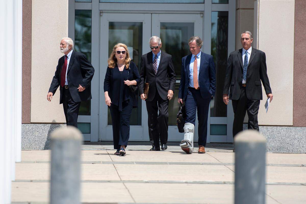 Clell Rosetti, an owner of Quality Poultry & Seafood, far left, his son Todd Rosetti, the sales manager, far right, and their attorneys walk out of the Dan M. Russell Jr. Courthouse in Gulfport on Tuesday, Aug. 27, 2024, after pleading guilty to conspiring with Mary Mahoney’s Old French House to mislabel cheaper foreign fish as Gulf seafood.