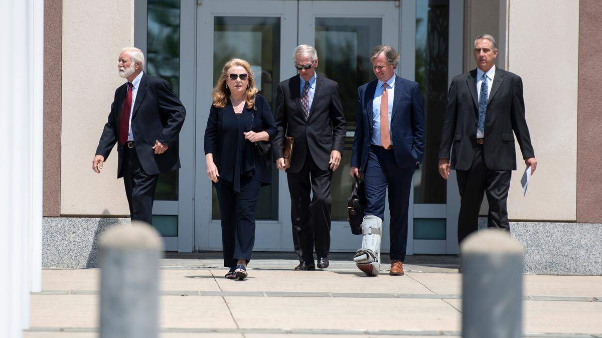 Clell Rosetti, an owner of Quality Poultry & Seafood, far left, his son Todd Rosetti, the sales manager, far right, and their attorneys walk out of the Dan M. Russell Jr. Courthouse in Gulfport on Tuesday, Aug. 27, 2024, after pleading guilty to conspiring with Mary Mahoney’s Old French House to mislabel cheaper foreign fish as Gulf seafood.