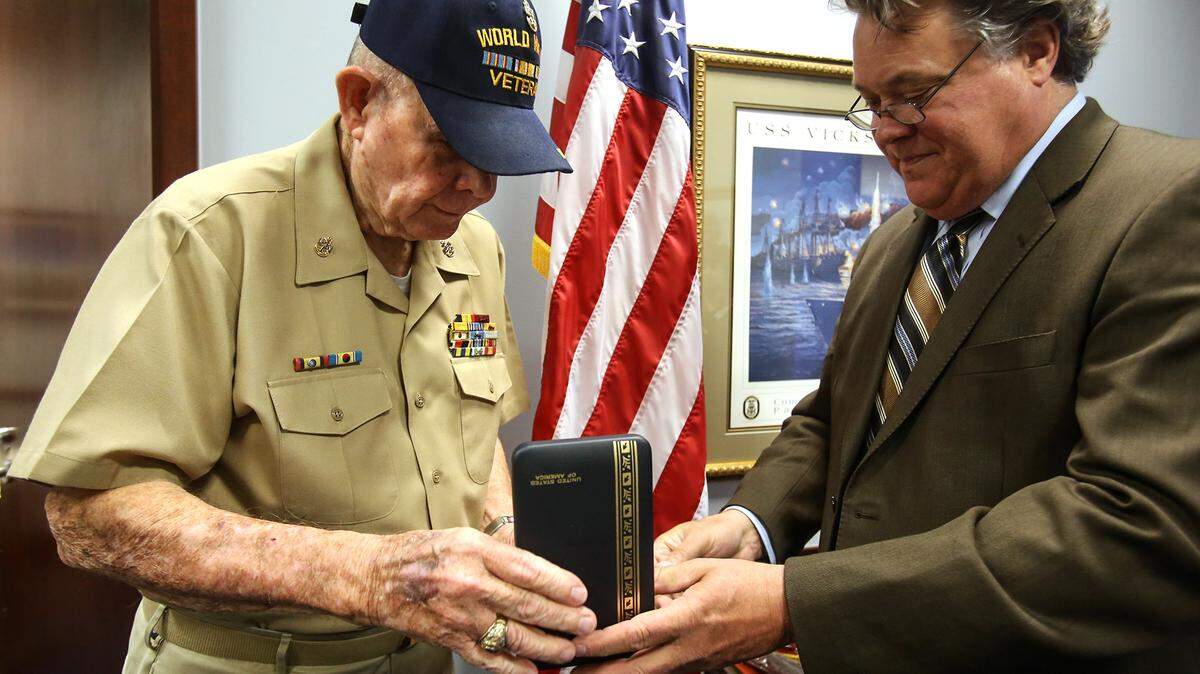 AMANDA McCOY/SUN HERALD 
 Francis Ward, left, receives medals his father, Frank G. Ward, won during World War I during ceremony at U.S. Senator Thad Cochran's office on Tuesday, March 29, 2016, in Gulfport. U.S Sen. Thad Cochran´s Chief of Staff, Keith Heard, presented Ward the Distinguished Service Cross, Purple Heart and French Fourragere all earned by his father.