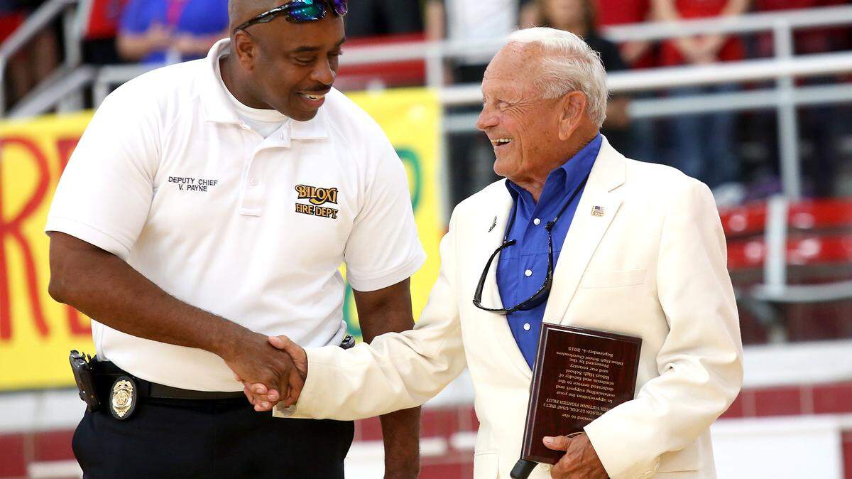 Biloxi Fire Department’s Vincent Payne shakes hands with Air Force veteran Dick Wilson during a special pep rally at Biloxi High on Friday, September 4, 2015. Wilson was presented Tuesday with the 2019 Pat Santucci Spirit of the Coast award.