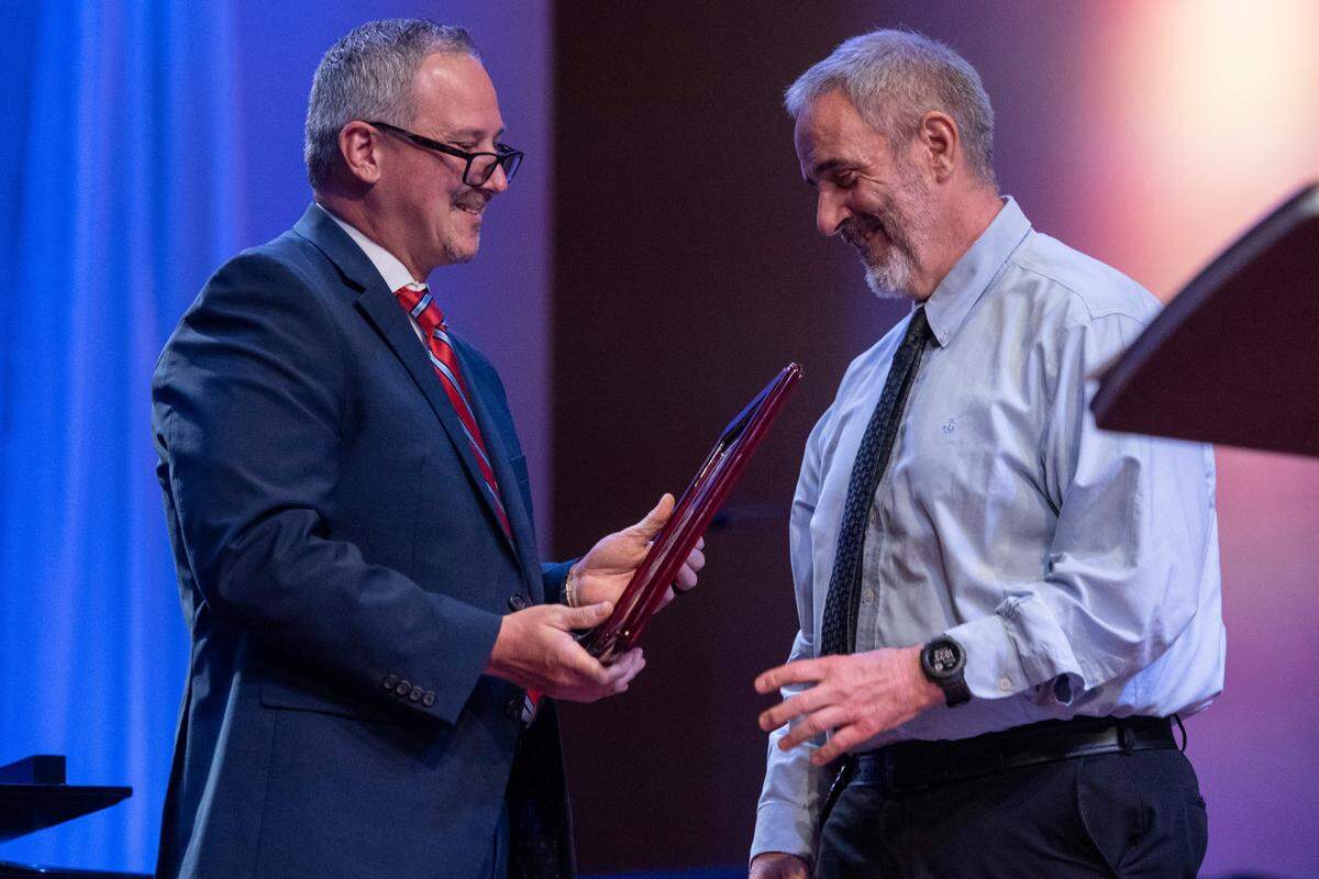 Assistant District Attorney Billy Stage, right, presents an award during a coast-wide candlelight ceremony as a part of National Crime Victims’ Rights Week at First Baptist Church of Gulfport on Tuesday, April 29, 2025.