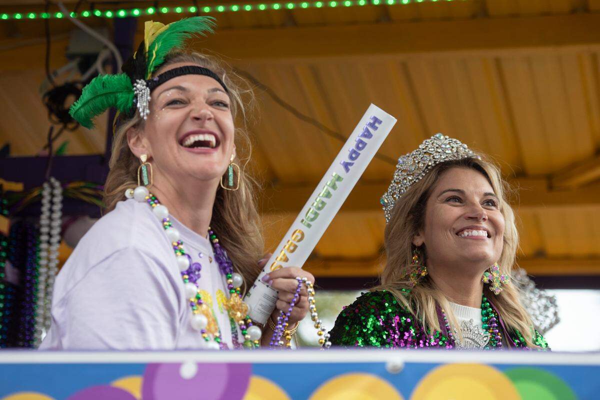 Float riders throw beads to the crowd during the Gulf Coast Carnival Association Mardi Gras parade in Biloxi on Tuesday, March 4, 2025.