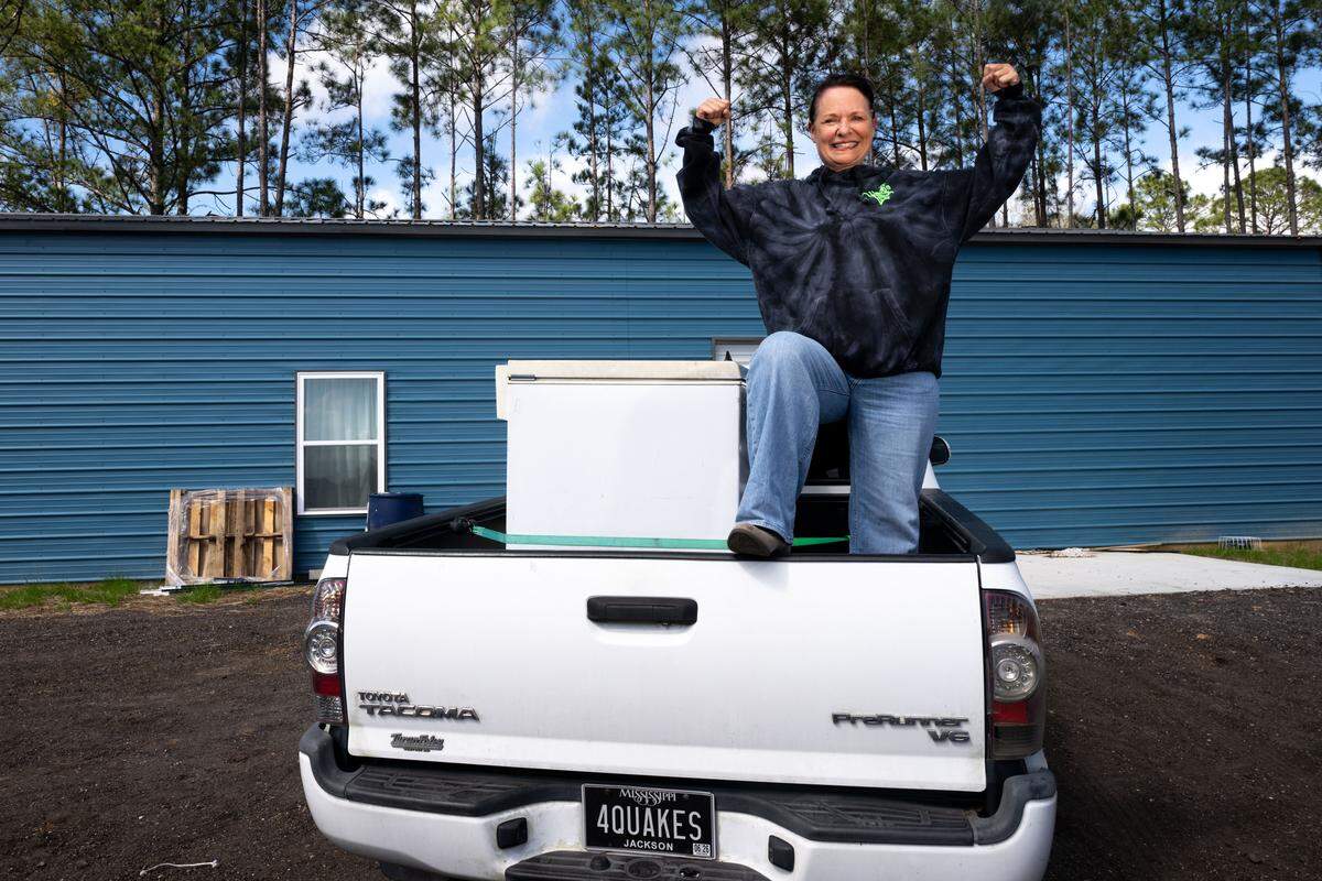 Marie Garbin poses for a portrait on top of a truck with chest for cooling ice cream at the Quakes distribution center in Vancleave on Thursday, March 5, 2026.
