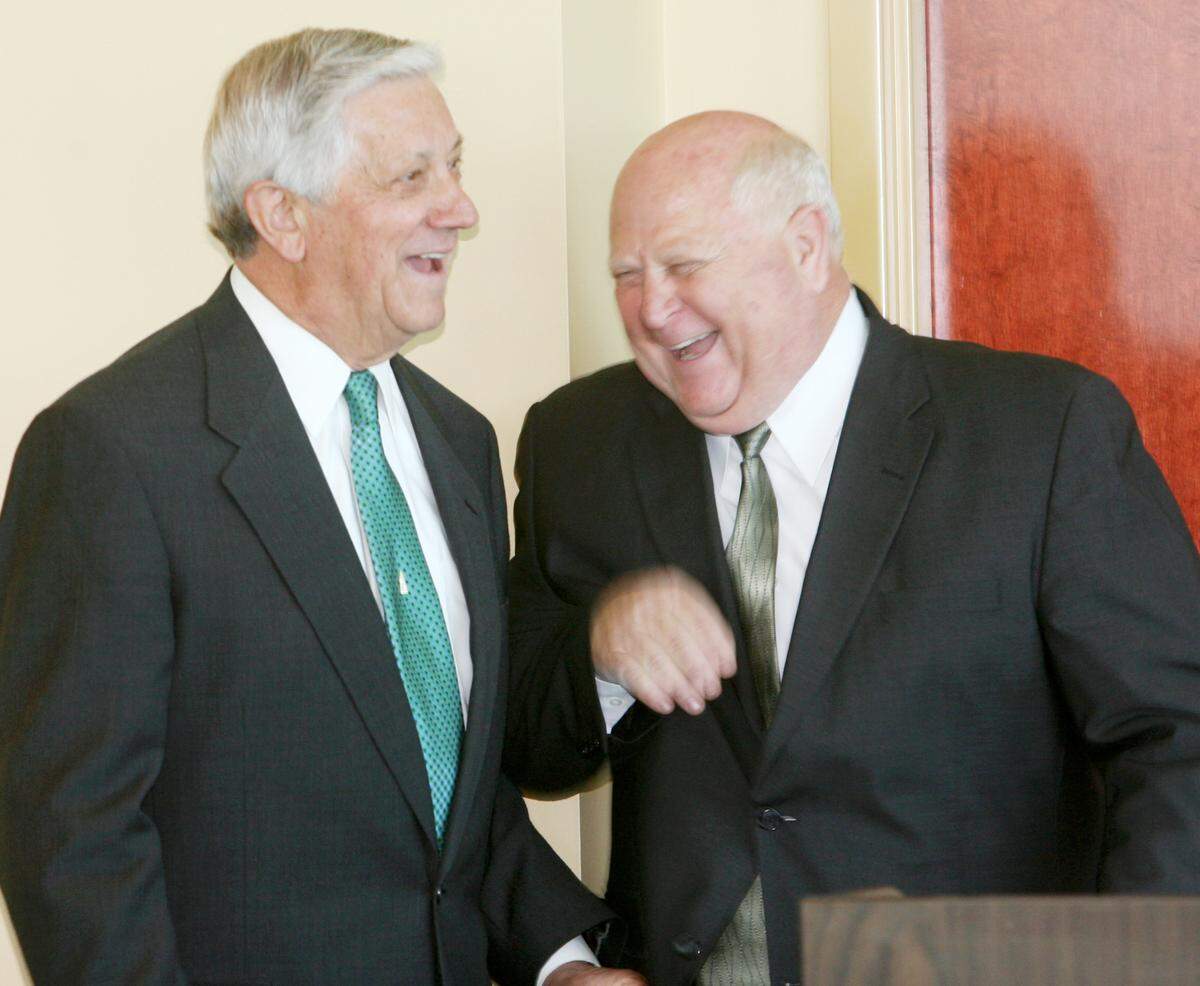 Gulfport mayoral candidates George Schloegel, left, and Joe Spraggins laugh Tuesday during their debate at the Gulfport Yacht Club.