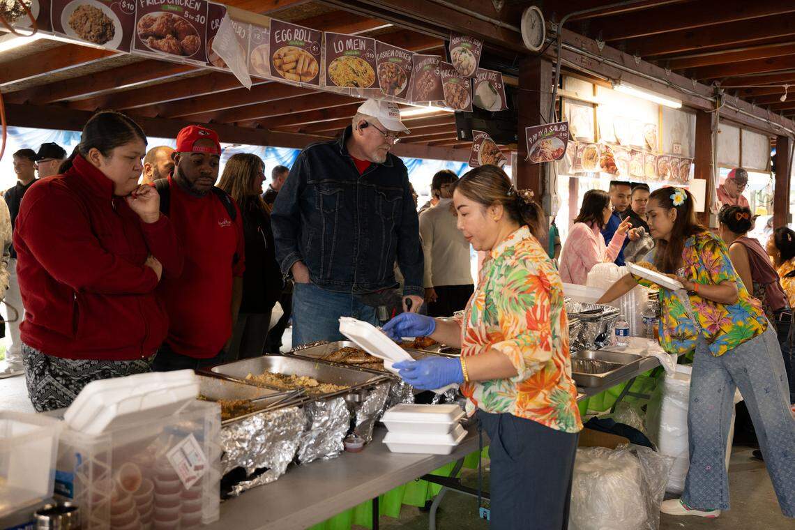 Hundreds wait in line to buy food during Songkran at the Wat Buddhametta Mahabaramee in Gautier on Sunday, April 19, 2026.