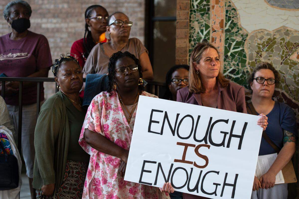 Members of We Shall Not Be Moved, a group protesting a proposed urban renewal plan for the city of Ocean Springs, stand outside the city Civic Center on Wednesday, Sept. 20, 2023.