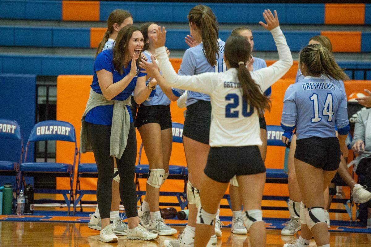 Ocean Springs’ Coach Christina Daigle congratulates her players after beating Gulfport at Gulfport High School in Gulfport on Tuesday, Oct. 4, 2022.