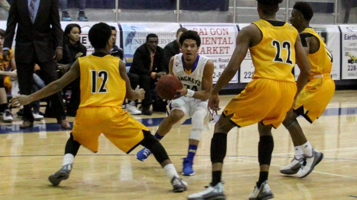 CHRISTOPHER BOSTICK/SUN HERALD 
 St. Martin's Stacee St. Julian goes for a shot surrounded by D'Iberville's defenders on January 26, 2016 in St. Martin.