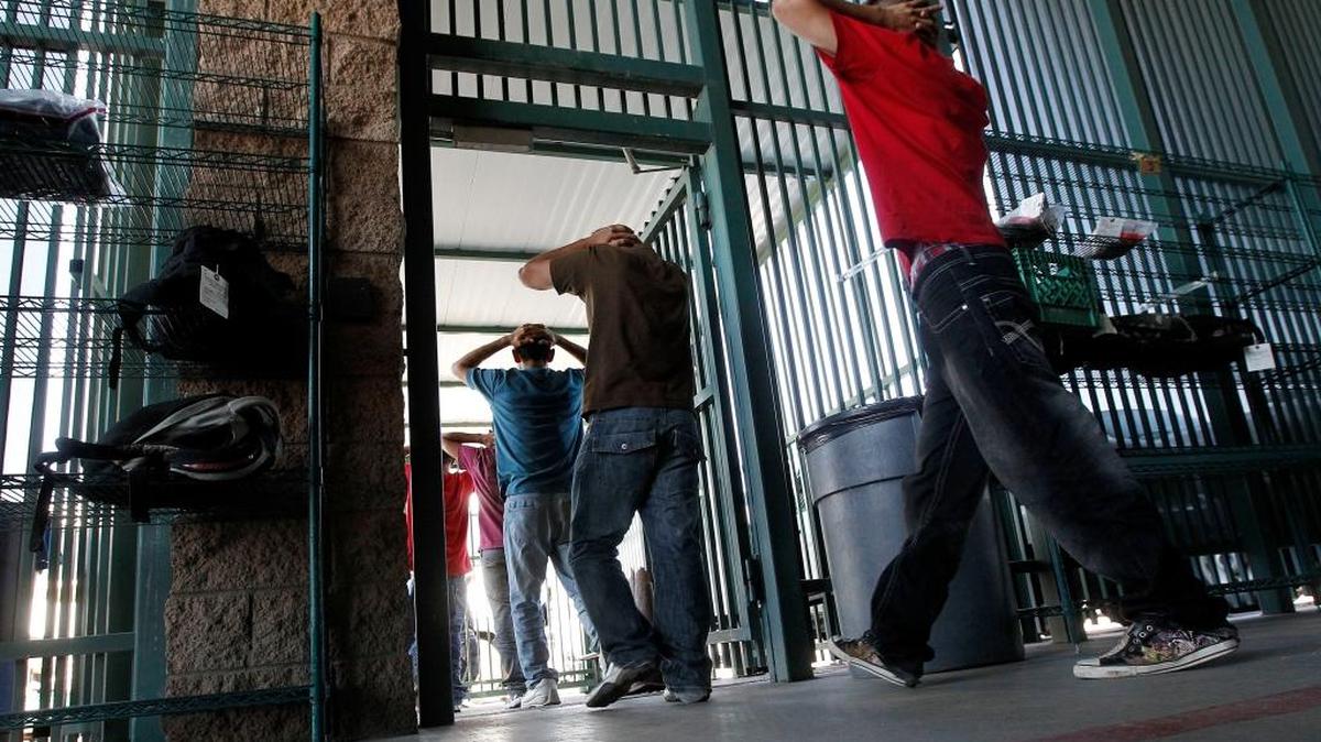 Illegal immigrants prepare to enter a bus after being processed at Tucson (Arizona) Sector U.S. Border Patrol headquarters in 2012.