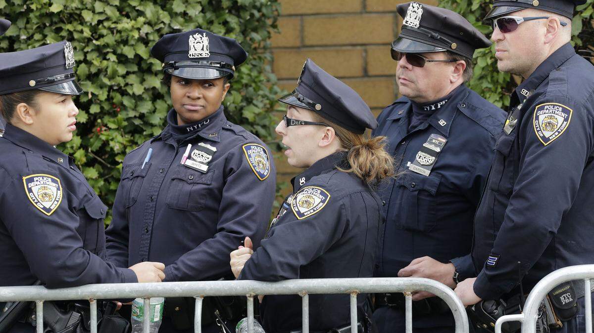 New York police officers arrive for the wake of fellow officer Randolph Holder at the Greater Allen A.M.E. Cathedral, Tuesday, Oct. 27, 2015, in the Queens borough of New York. Holder was shot and killed Tuesday, Oct. 20 while pursuing a suspect in the Harlem neighborhood of New York. The suspect was caught several blocks away with a gunshot wound to his leg. (AP Photo/Mark Lennihan)