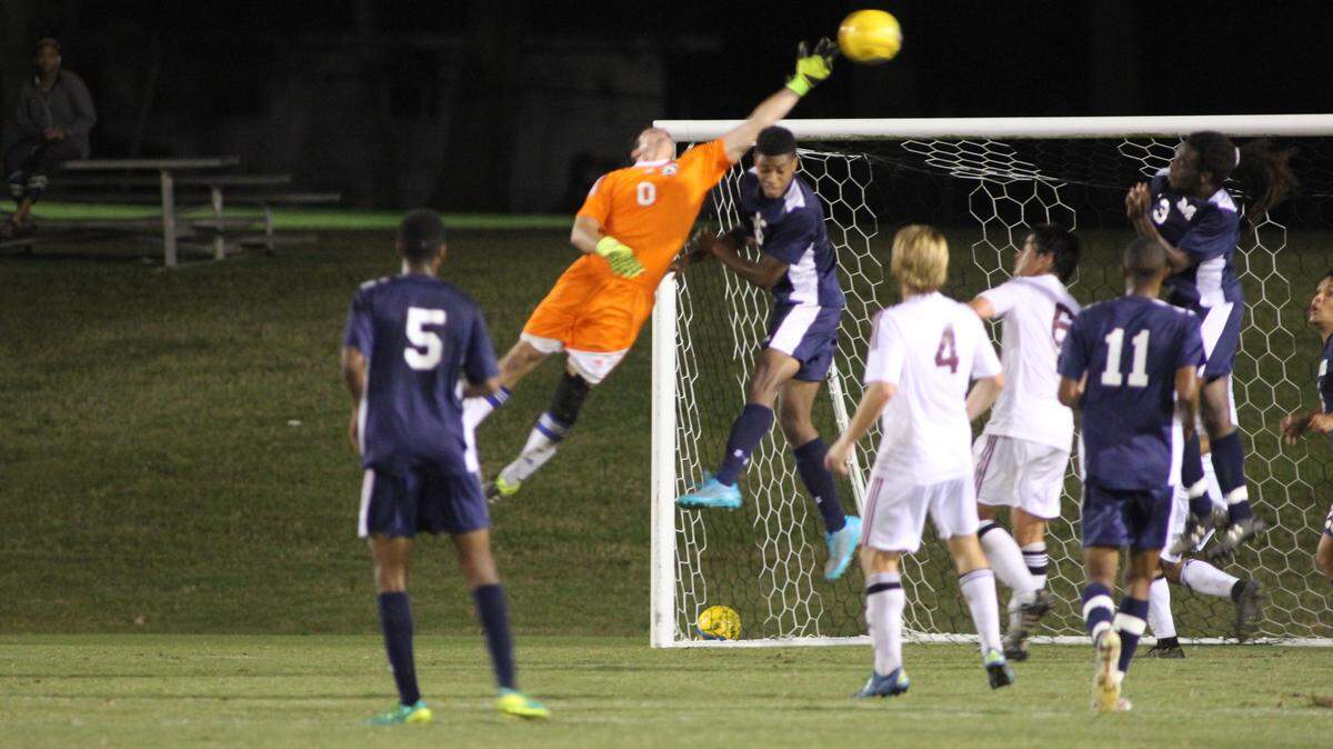 TRACY DUNCAN/HINDS COMMUNITY COLLEGE 
 Mississippi Gulf Coast keeper Bryce Yelverton tries to clear a Hinds cross.
