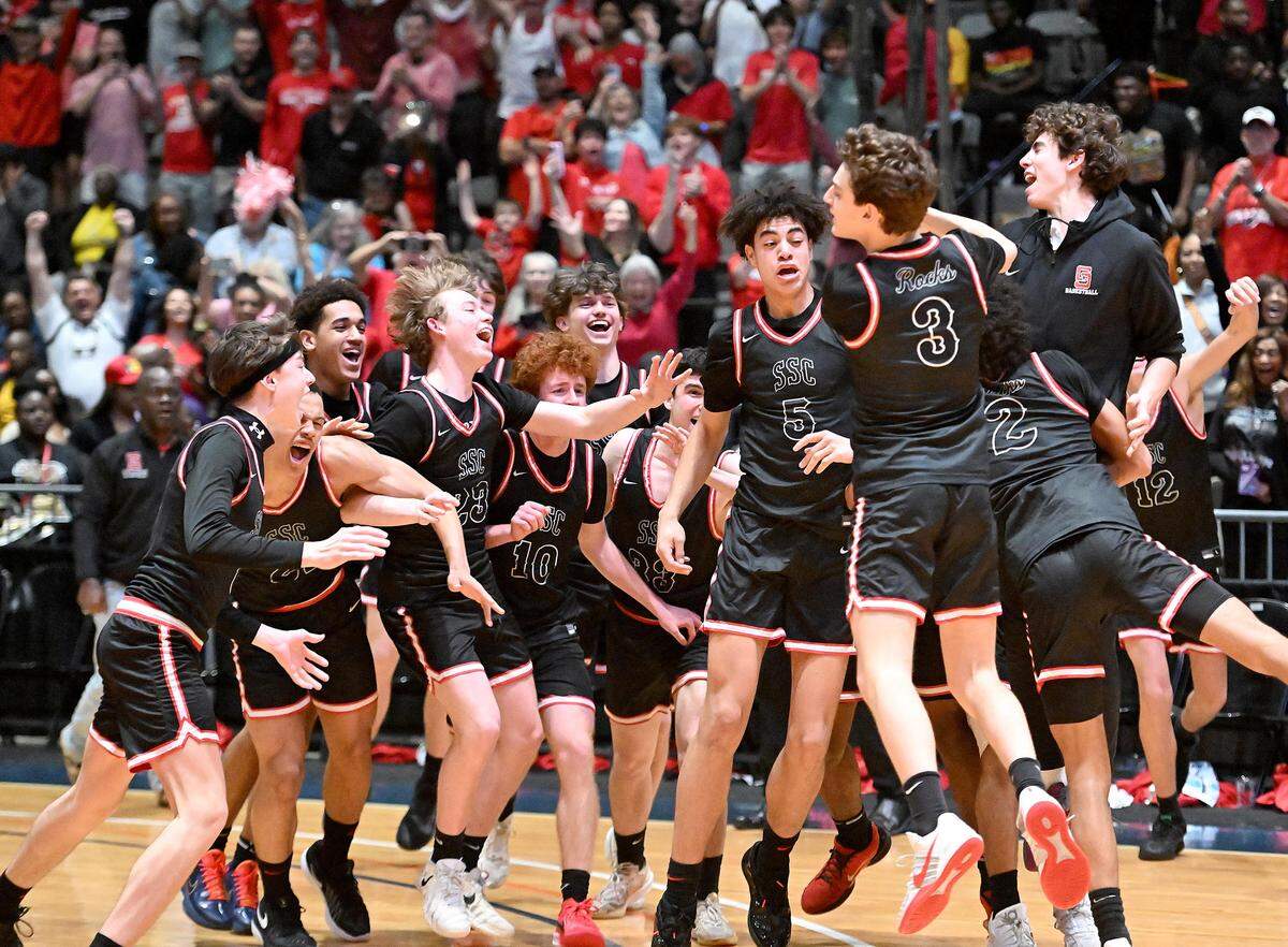 The St. Stanislaus Catholic Rock-A-Chaws celebrate after the final whistle Saturday.