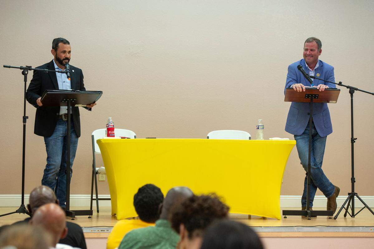 Louis Elias, left, and Matt Haley, right, candidates for Harrison County sheriff, answer questions during a debate moderated by Rip Daniels at Saint Paul United Methodist church in Biloxi on Tuesday, June 27, 2023.