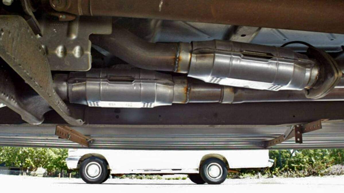 A catalytic converter is near the exhaust pipe underneath a vehicle. The converter has been required on vehicles manufactured since 1975 to decrease harmful pollutants. But they can be cut off and stolen quickly, making a thief some quick bucks but causing the auto owner a costly replacement job.