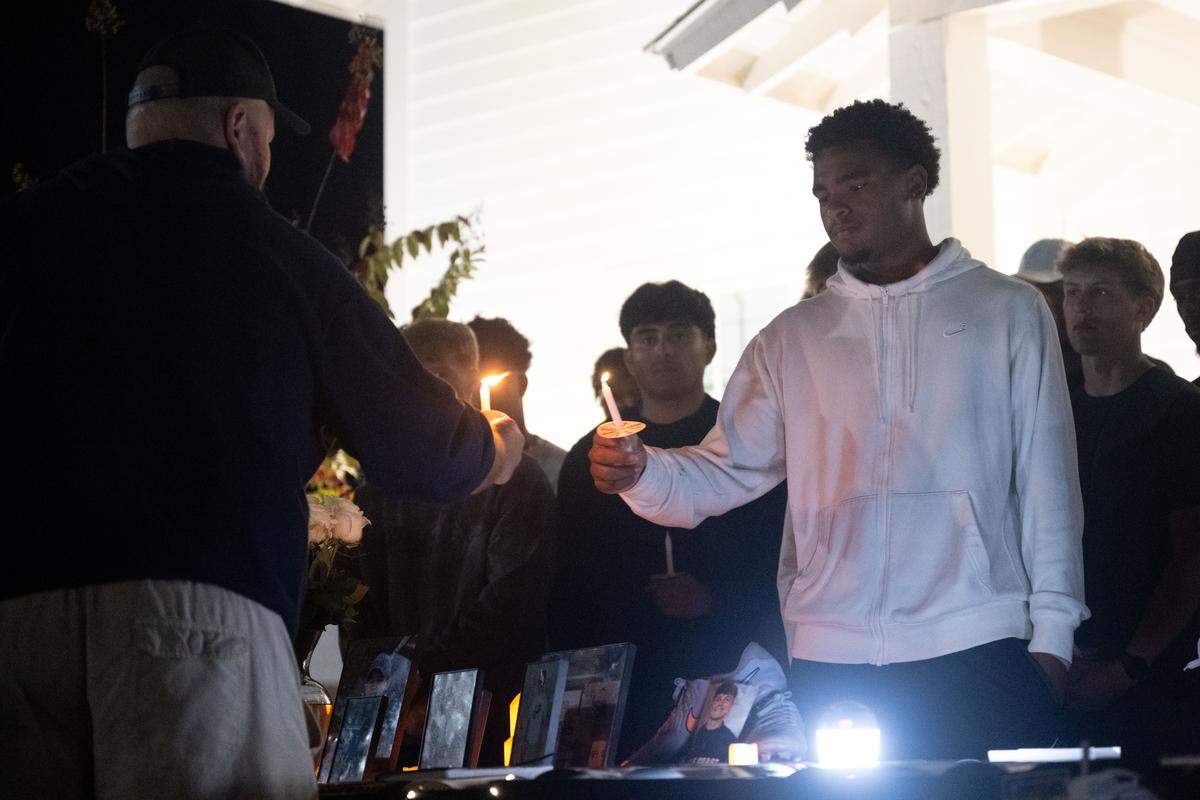 Josh Perry lights candles for attendees.