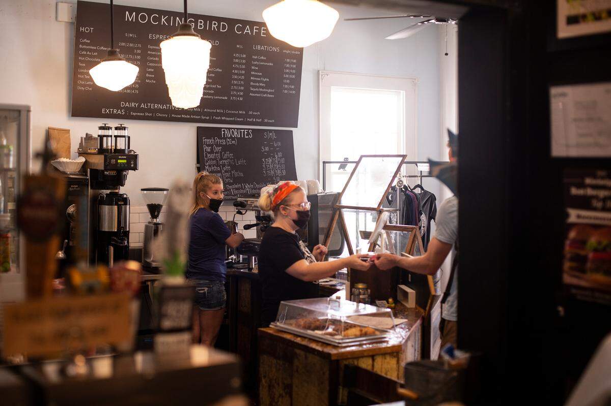 Employees at Mockingbird Cafe in downtown Bay St. Louis serve guests on May 27, 2020. The popular coffee shop and restaurant has no plans of reopening their dining room anytime soon during the coronavirus pandemic.