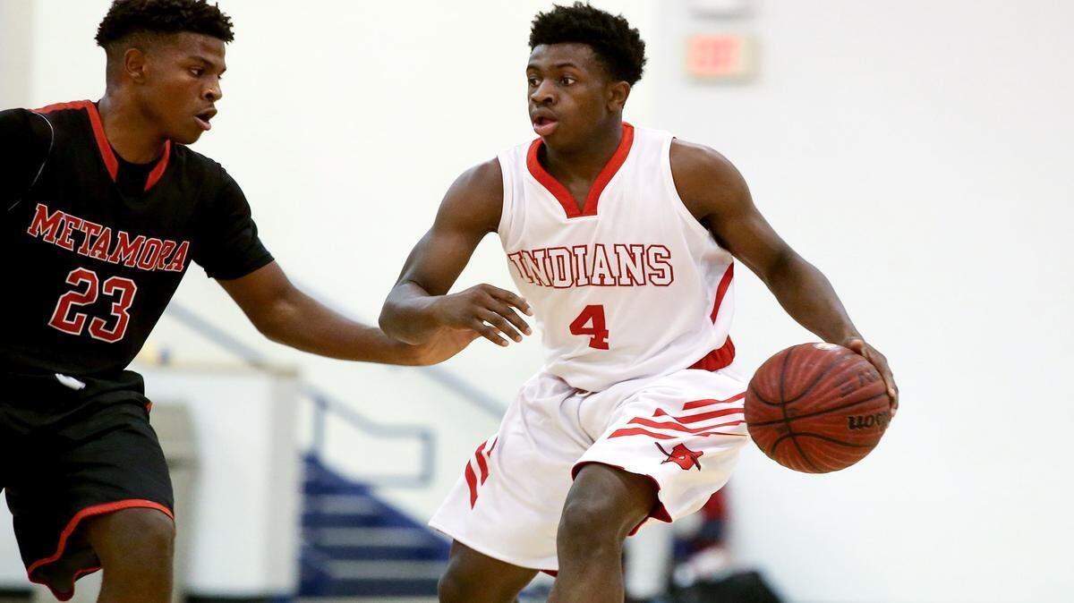 AMANDA McCOY/SUN HERALD 
 Biloxi's Jaylon Chiles dribbles the ball while guarded by Metamora's Dallas Morgan during the second day of the Gulfport Hardwood Holiday Classic on Tuesday, December 29, 2015.