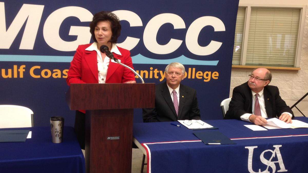 KAREN NELSON/SUN HERALD 
 Mississippi Gulf Coast Community College President Mary Graham announces a new pathways program that allows students to transition smoothly to the University of South Alabama in Mobile. At Tuesday's ceremony was Tony Waldrop, president of USA, center, and David Johnson, Provost at USA.