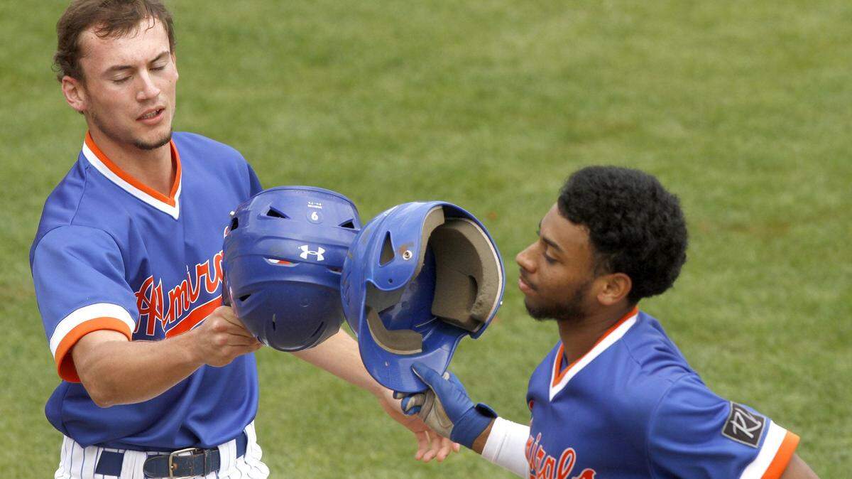 TIM ISBELL/SUN HERALD 
 Gulfport's Ethan Saucier (left) congratulates teammate Kevin Carter after he hit a sacrifice to score Saucier against Oak Grove, Saturday, March 26, 2016.