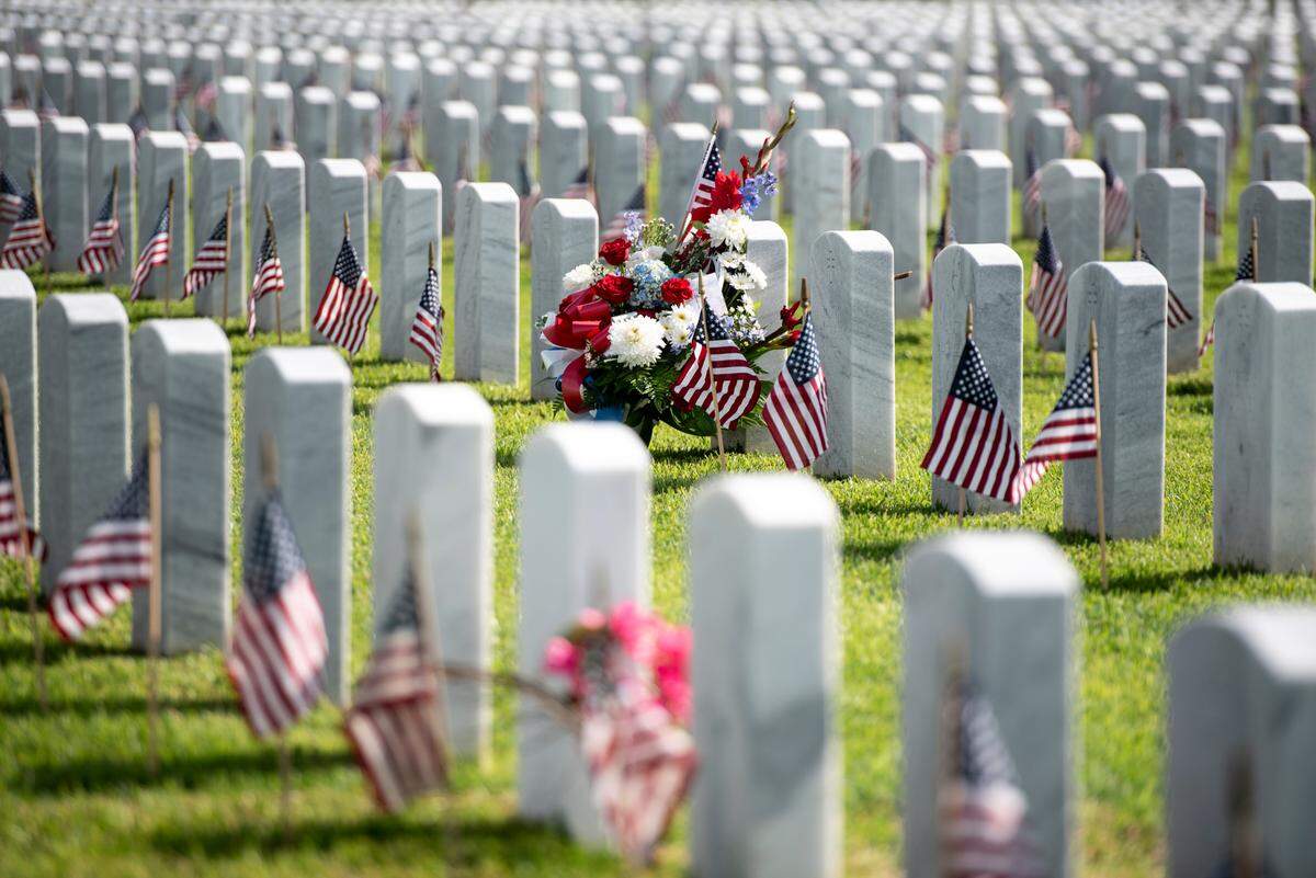 Thousands of tiny American flags decorate the graves of American service members at Biloxi National Cemetery in Biloxi ahead of Memorial Day on Saturday, May 25, 2024.