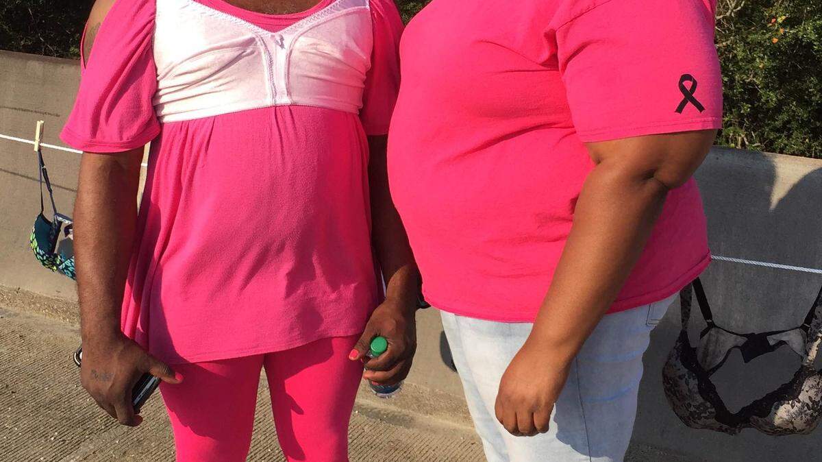 JEFF CLARK/SPECIAL TO THE SUN HERALD 
 Harold and Shae Narcisse wear their brightest pink as they walk across the bridge over the Escatawpa River for the fifth annual "Bras Across the River" on Saturday, Oct. 10, 2015.