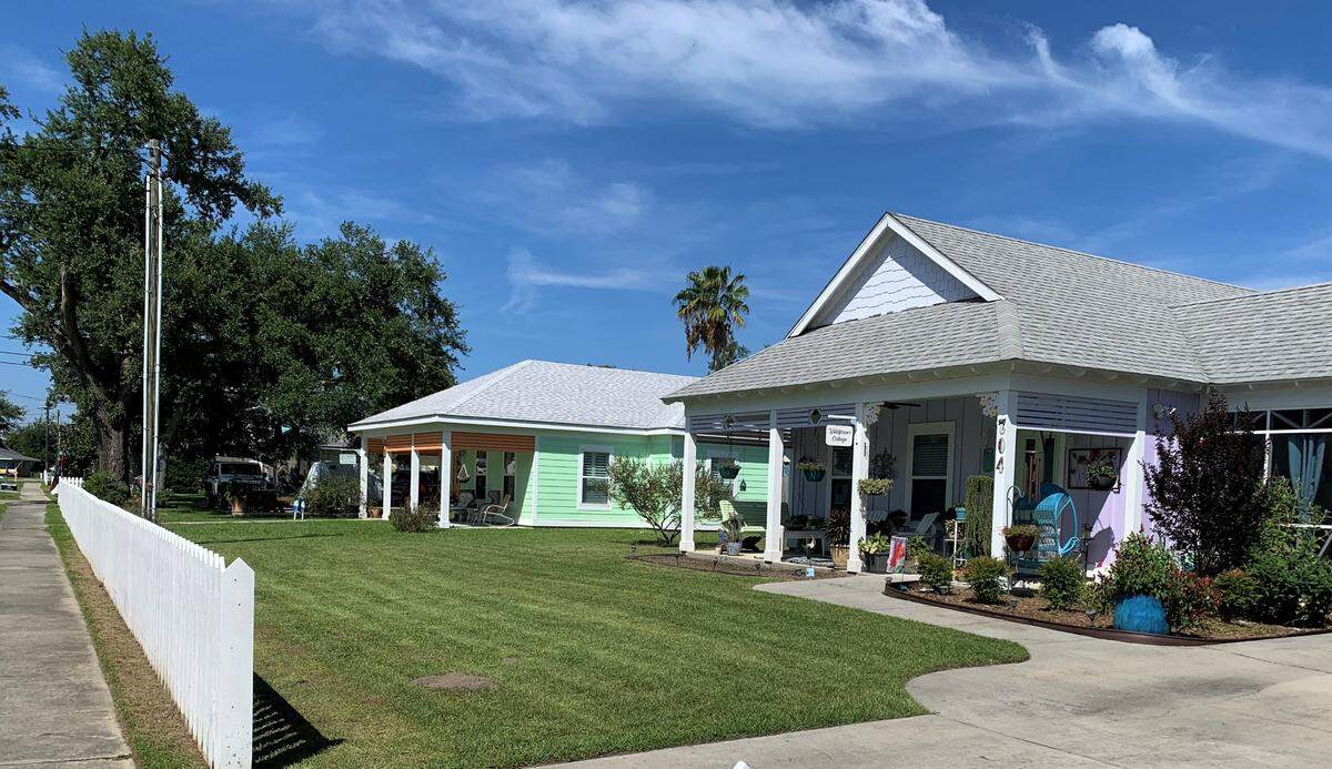 Long Beach developers Dale and Shelia Stennett built Key West style homes in lavender, lemon and lime colors along Sycamore Street in Long Beach, complete with a picket fence.