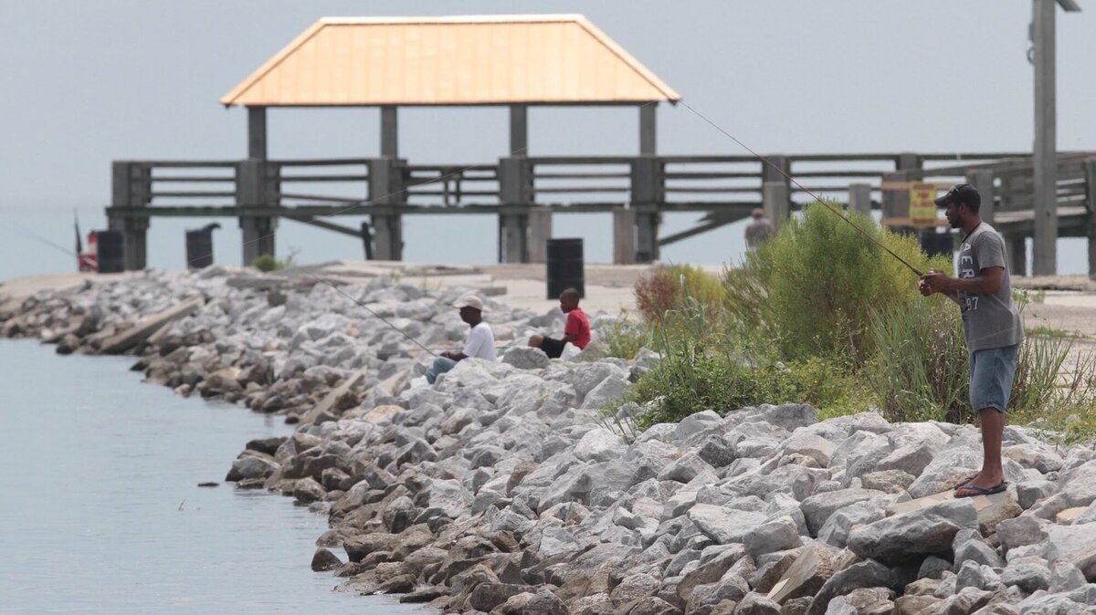 Fishermen fish from Moses Pier at the Gulfport Small Craft Harbor. The state has three days designated for fishing without a license, only one of which holds for saltwater fishing.