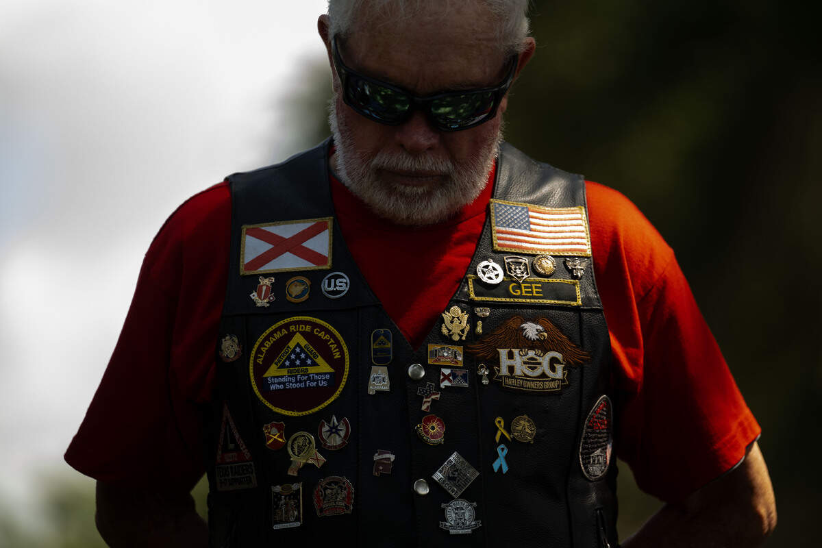 Gerald Hagan lowers his head for a prayer during a ceremony at Biloxi National Cemetery on Saturday, July 11, 2026.