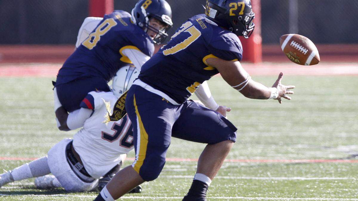 TIM ISBELL/SUN HERALD 
 Rochester running back Devon Robinson catches a pass from Nick Rooney during the Mississippi Bowl, Sunday, Dec. 6, 2015.