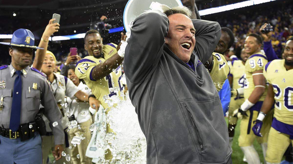 Alcorn State head coach Jay Hopson is doused with liquid after Alcorn State defeated Grambling State 49-21 in the Southwestern Athletic Conference championship college football game, Saturday, Dec. 5, 2015, in Houston. (AP Photo/Eric Christian Smith)