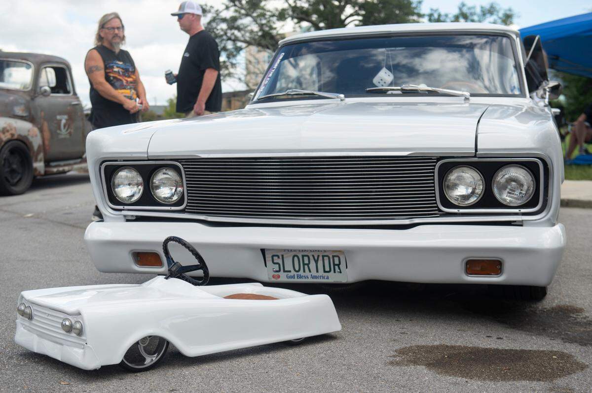 A mini version of a classic car is parked in front of it during View the Cruise, one of the first events of Cruisin’ The Coast, in Gulfport on Sunday, Oct. 6, 2024.